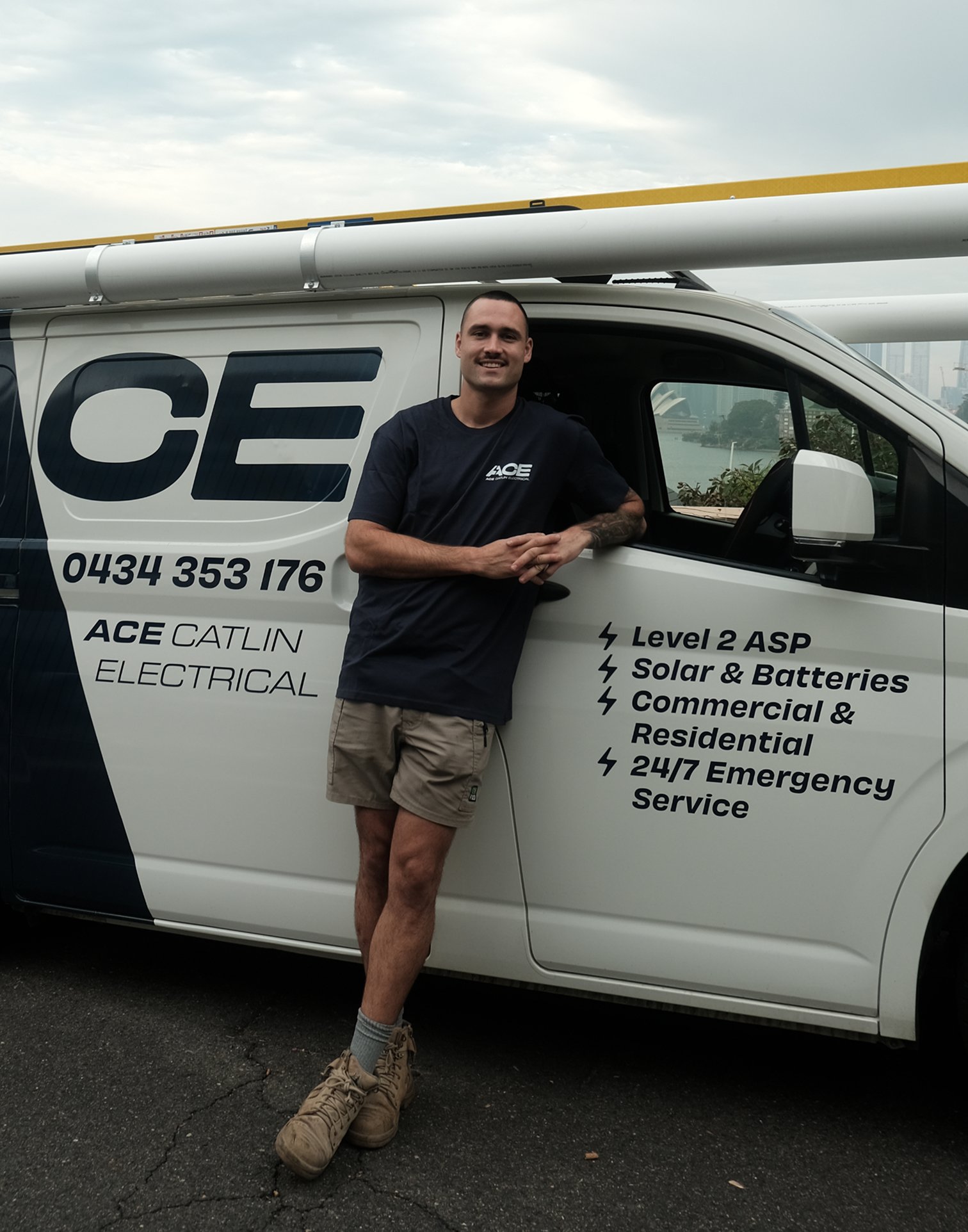 Ace Catlin Electrical technician standing beside branded service van
