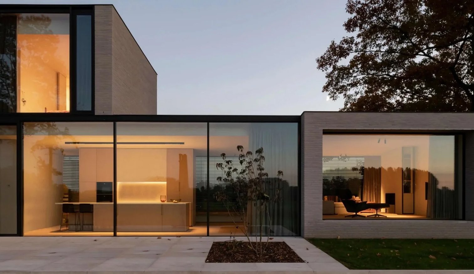 Contemporary Sydney home exterior with pool and glass facade at dusk