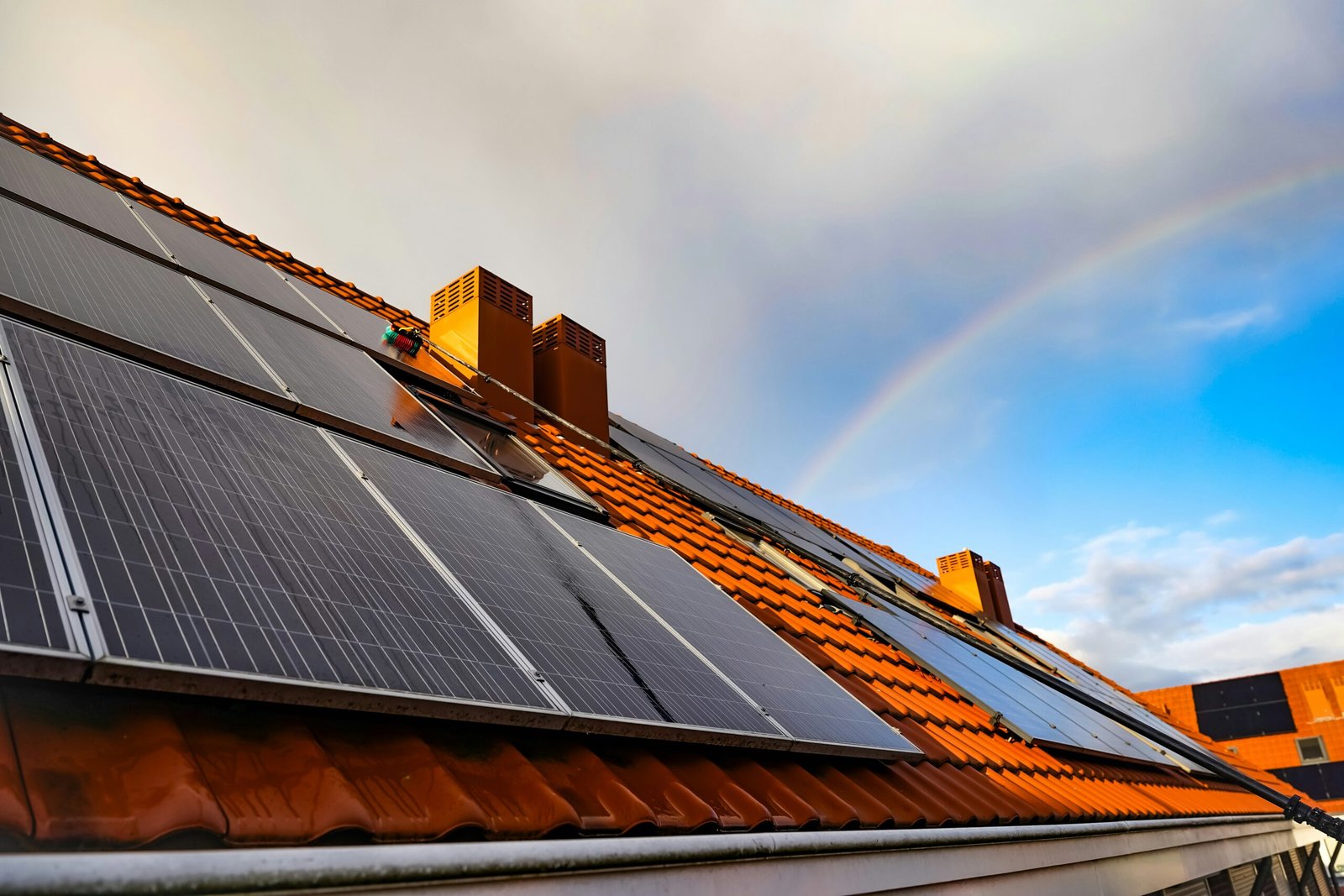 Solar panel installation on a residential roof at sunset