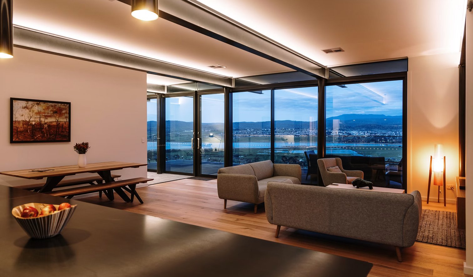 Modern apartment living room with skyline view and ceiling downlights