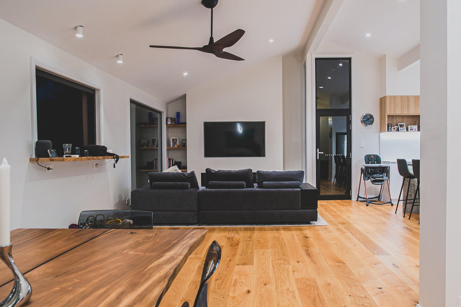 Open-plan kitchen and living area with pendant and downlighting in a Wahroonga home