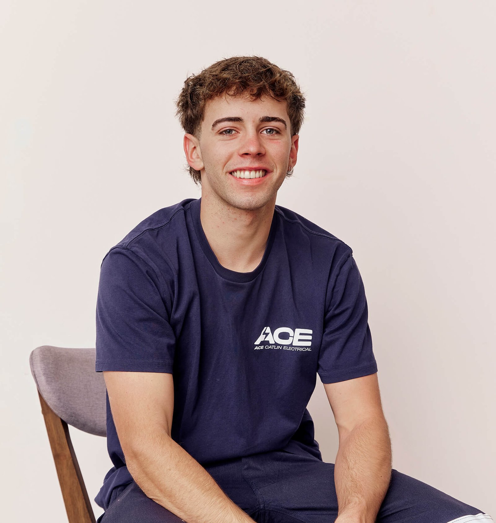 Young Ace Catlin Electrical electrician in navy branded polo shirt
