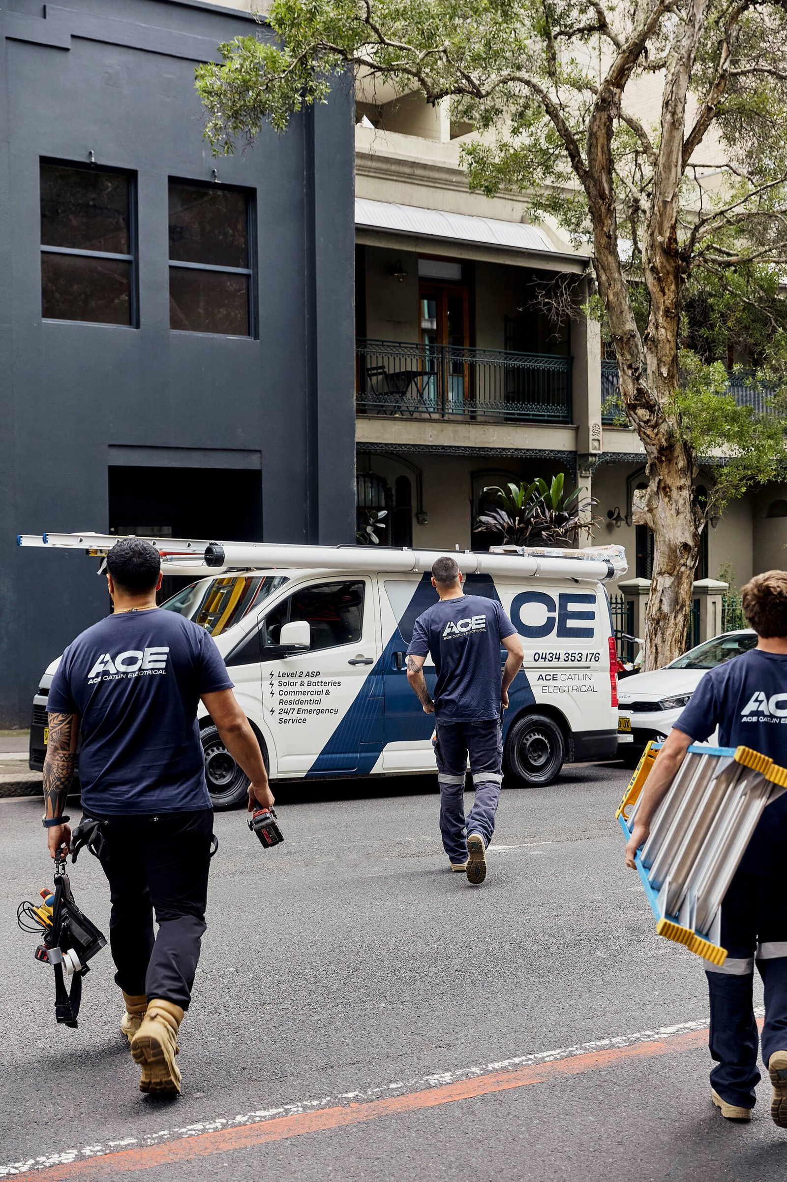 Ace Catlin Electrical team member outside a Sydney apartment building job site